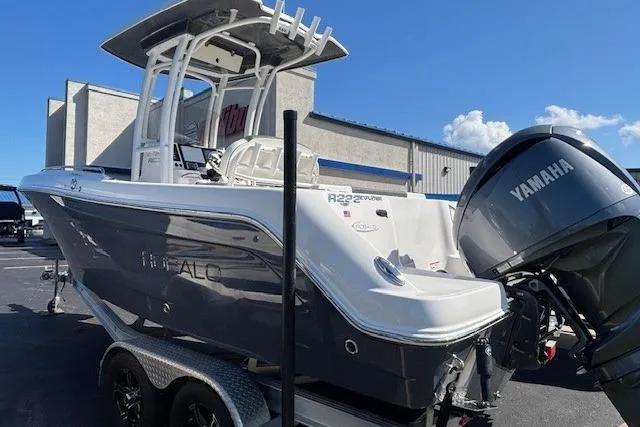 Slide: The Image of 2022 Robalo R222 Explorer boat with Yamaha engine, parked on a trailer. - 49