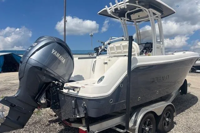 Slide: The Image of 2022 Robalo R222 Explorer boat with Yamaha engine on trailer, under blue sky. - 5