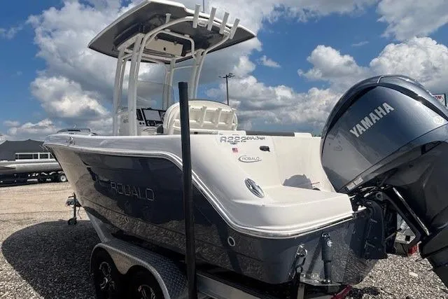 Slide: The Image of 2022 Robalo R222 Explorer boat with Yamaha engine, parked on a trailer under a cloudy sky. - 8