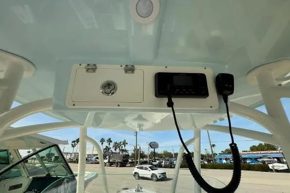 Slide: The Image of 2024 Sailfish 242 CC boat console with radio and storage compartment. - 10