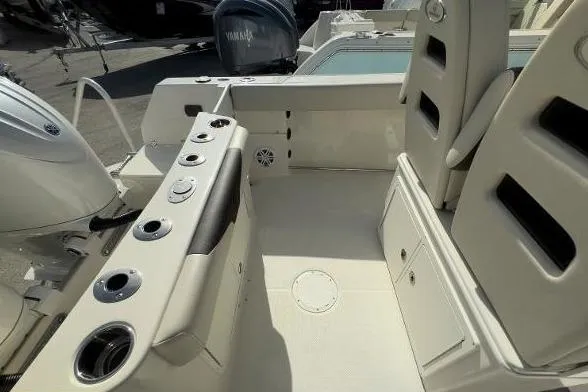 Slide: The Image of 2024 Sailfish 242 CC boat interior with seating and fishing rod holders. - 12