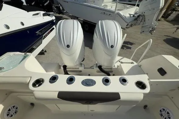 Slide: The Image of 2024 Sailfish 242 CC boat with dual outboard engines, rear view. - 13