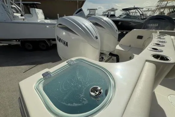 Slide: The Image of 2024 Sailfish 242 CC boat with Yamaha engines and livewell on deck. - 14