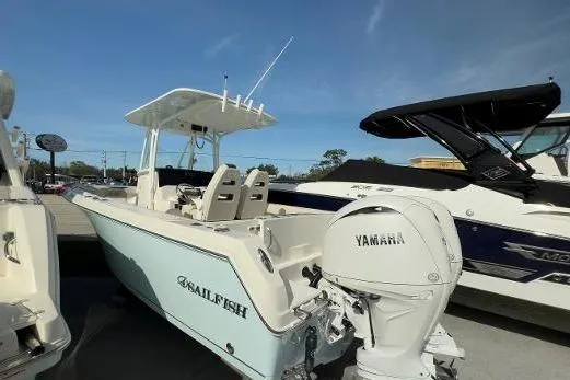 Slide: The Image of 2024 Sailfish 242 CC boat with Yamaha engine, docked outdoors under clear sky. - 17