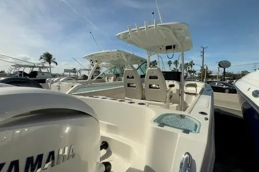 Slide: The Image of 2024 Sailfish 242 CC boat with Yamaha engine, docked under clear blue sky. - 19
