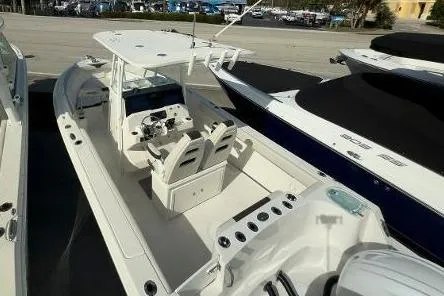 Slide: The Image of 2024 Sailfish 242 CC boat with spacious deck and dual seating arrangement. - 20