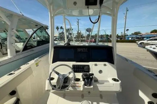 Slide: The Image of 2024 Sailfish 242 CC boat cockpit with steering wheel and control panel. - 21