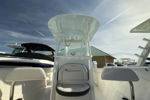 Slide: The Image of 2024 Sailfish 242 CC boat with center console and seating, under a clear sky. - 5