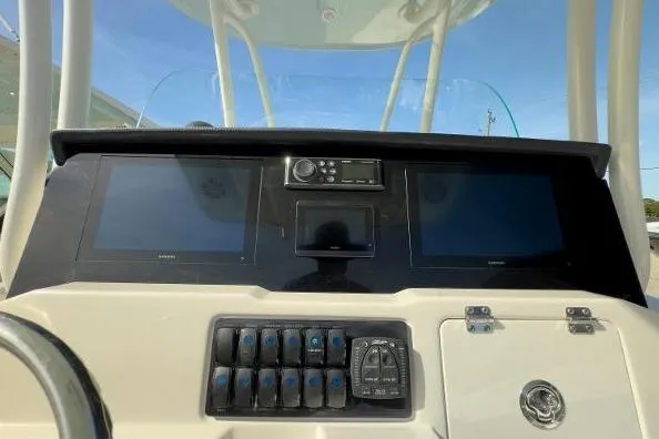 Slide: The Image of 2024 Sailfish 242 CC boat dashboard with dual screens and control panel. - 9