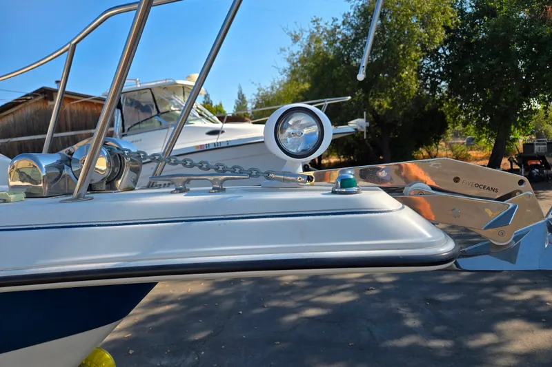 Slide: The Image of Bow of 1995 Regal Commodore 258 with anchor and spotlight, outdoors. - 10