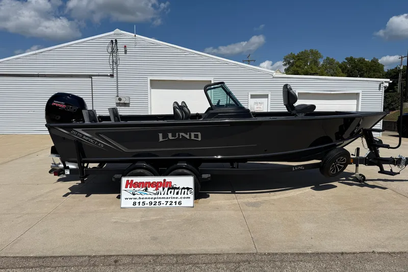The Image of 2025 Lund 2075 Impact XS boat on trailer at Hennepin Marine dealership. - 0