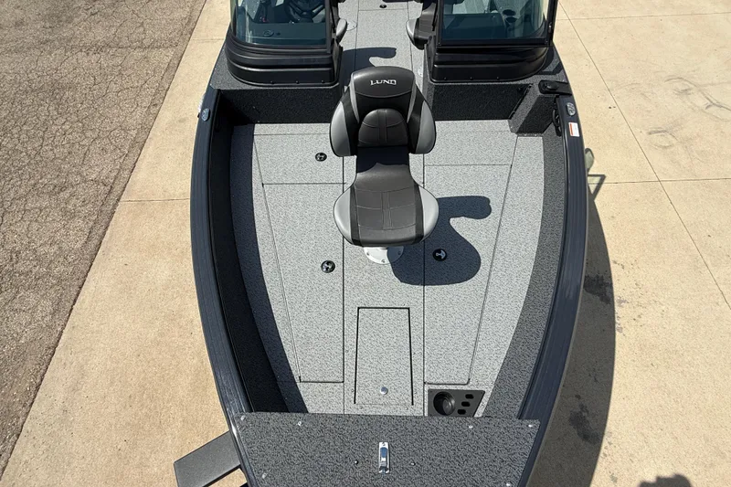 Slide: The Image of 2025 Lund 2075 Impact XS boat interior with seating and storage compartments. - 11