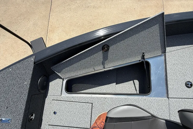 Slide: The Image of 2025 Lund 2075 Impact XS boat interior with open storage compartment. - 13
