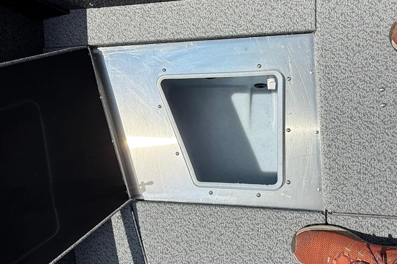 Slide: The Image of Open storage compartment on 2025 Lund 2075 Impact XS boat deck. - 14