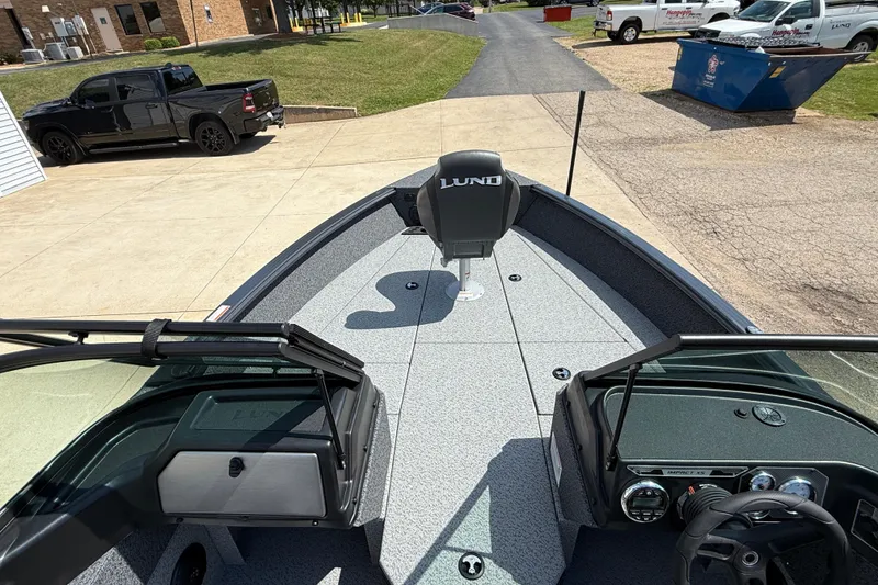 Slide: The Image of 2025 Lund 2075 Impact XS boat interior with steering console and seating. - 15