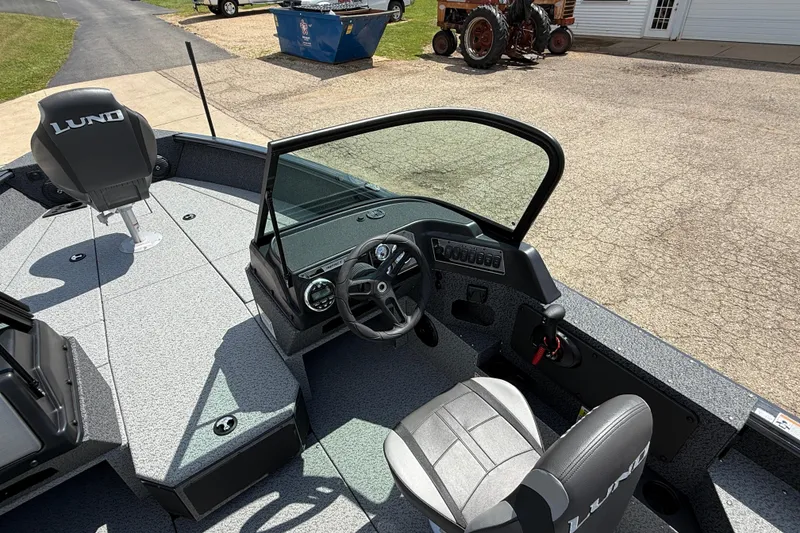 Slide: The Image of 2025 Lund 2075 Impact XS boat interior with steering wheel and seating. - 20