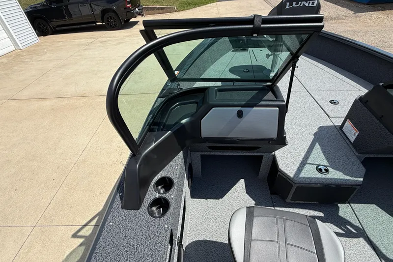 Slide: The Image of 2025 Lund 2075 Impact XS boat interior with open windshield and seating. - 23