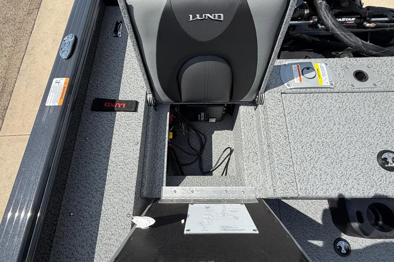 Slide: The Image of 2025 Lund 2075 Impact XS boat interior, featuring storage compartment and seating. - 29