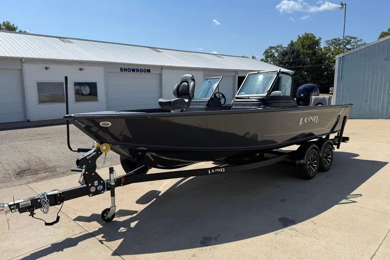 Slide: The Image of 2025 Lund 2075 Impact XS boat on trailer outside showroom. - 3