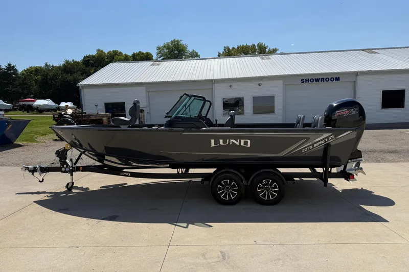 Slide: The Image of 2025 Lund 2075 Impact XS boat on trailer outside showroom. - 4