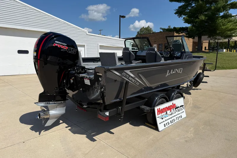 Slide: The Image of 2025 Lund 2075 Impact XS boat with Mercury Pro XS engine, parked outdoors. - 7