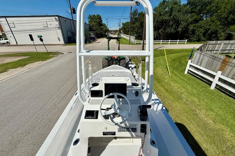 Slide: The Image of 2022 Shallow Sport 24 Modified V boat on a street, showcasing helm and controls. - 10