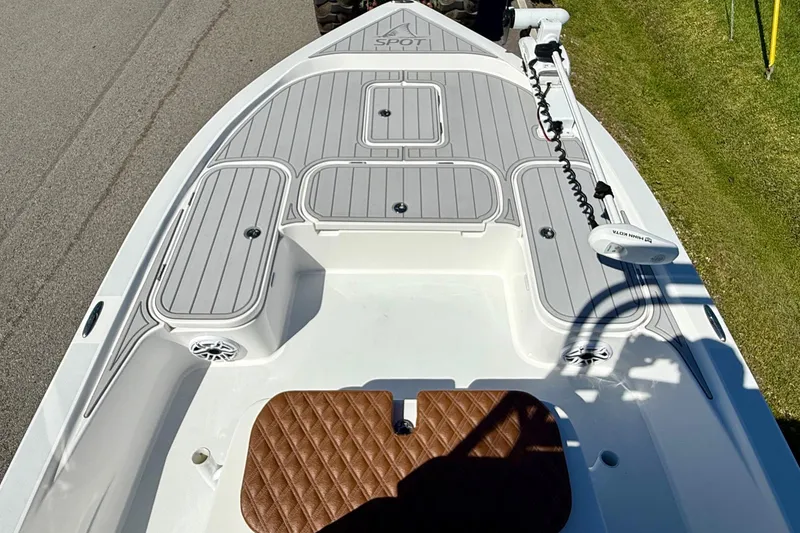 Slide: The Image of 2022 Shallow Sport 24 Modified V boat deck with seating and storage compartments. - 13