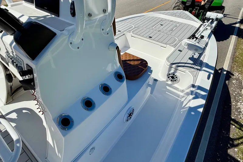 Slide: The Image of 2022 Shallow Sport 24 Modified V boat interior with rod holders and seating. - 14