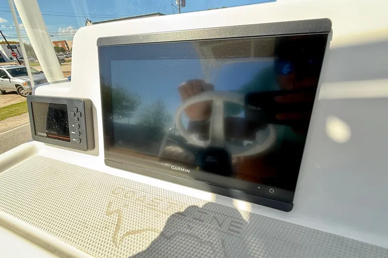 Slide: The Image of Console of 2022 Shallow Sport 24 Modified V with Garmin and Yamaha displays. - 16