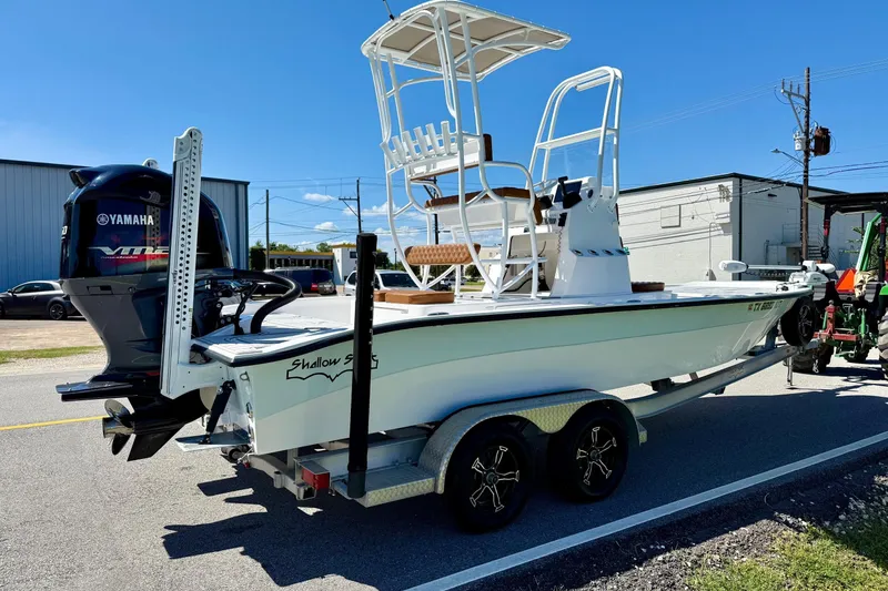 Slide: The Image of 2022 Shallow Sport 24 Modified V boat on trailer with Yamaha engine, parked outdoors. - 4