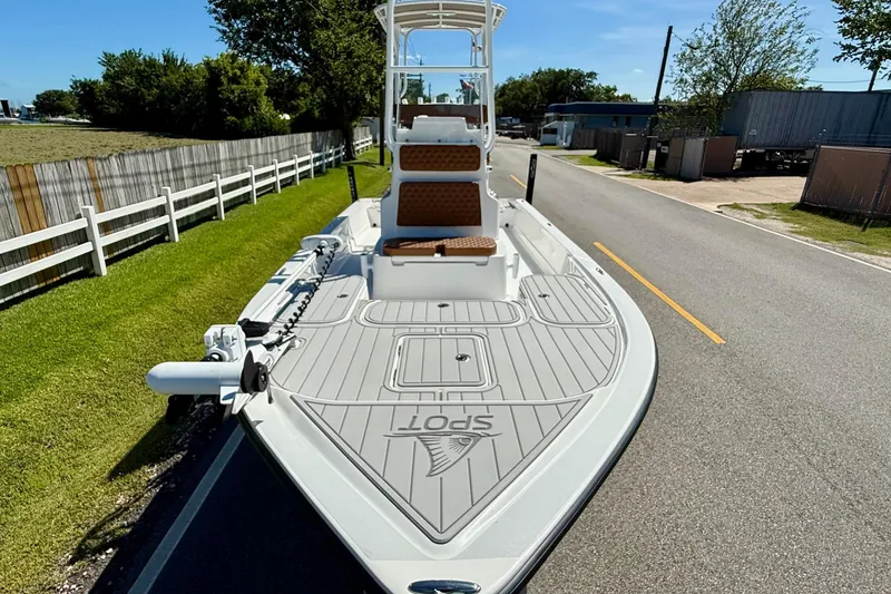 Slide: The Image of 2022 Shallow Sport 24 Modified V boat on a road, showcasing deck and seating. - 6