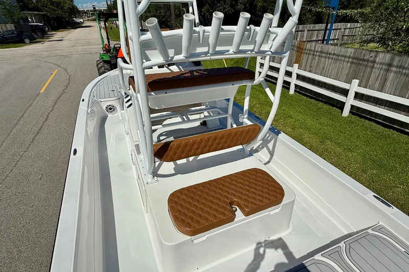 Slide: The Image of 2022 Shallow Sport 24 Modified V boat with brown cushioned seating and rod holders. - 8