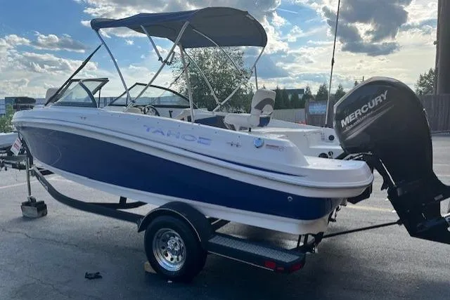 Slide: The Image of 2018 Tahoe 550 TF boat with Mercury engine on trailer, parked outdoors. - 2