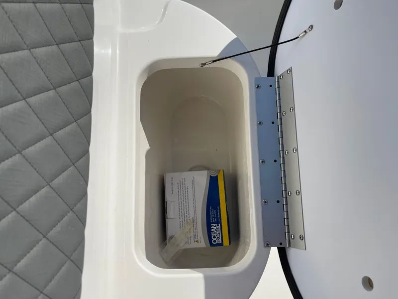 Slide: The Image of Key West 203 FS 2025 boat storage compartment with cushioned seating. - 11