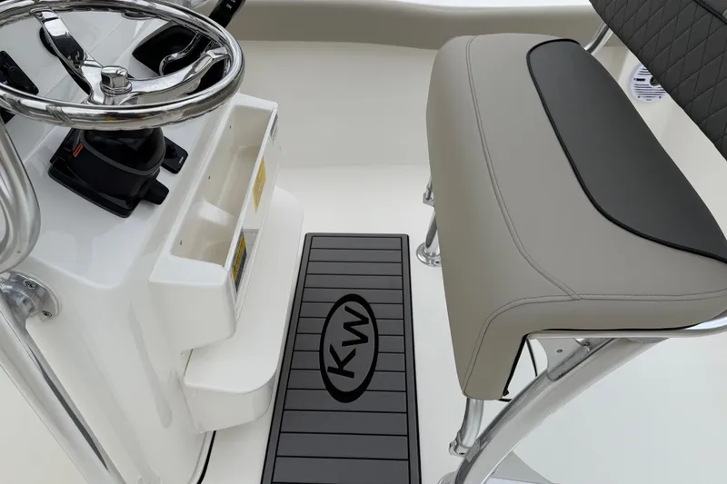 Slide: The Image of 2026 Key West 203 FS boat interior with steering wheel and cushioned seat. - 17