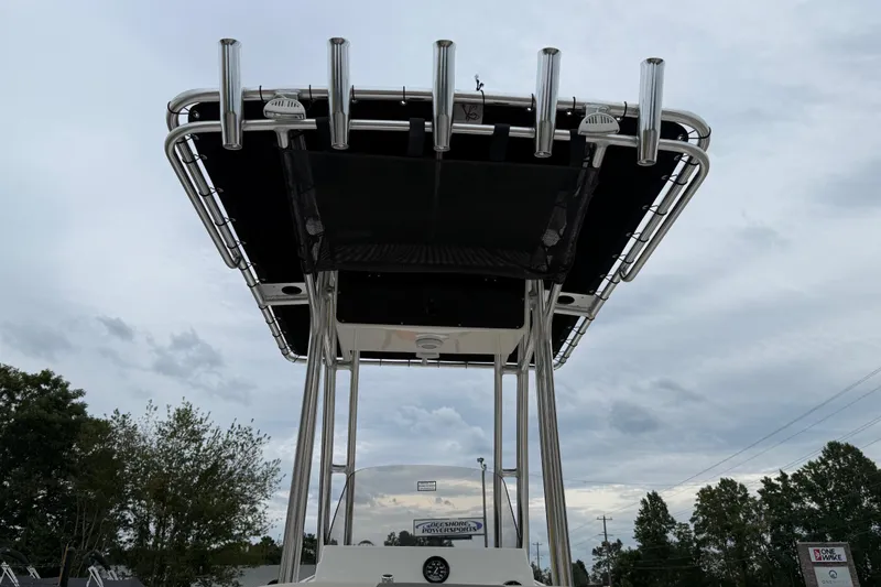 Slide: The Image of 2026 Key West 203 FS boat with T-top and rod holders against cloudy sky. - 22