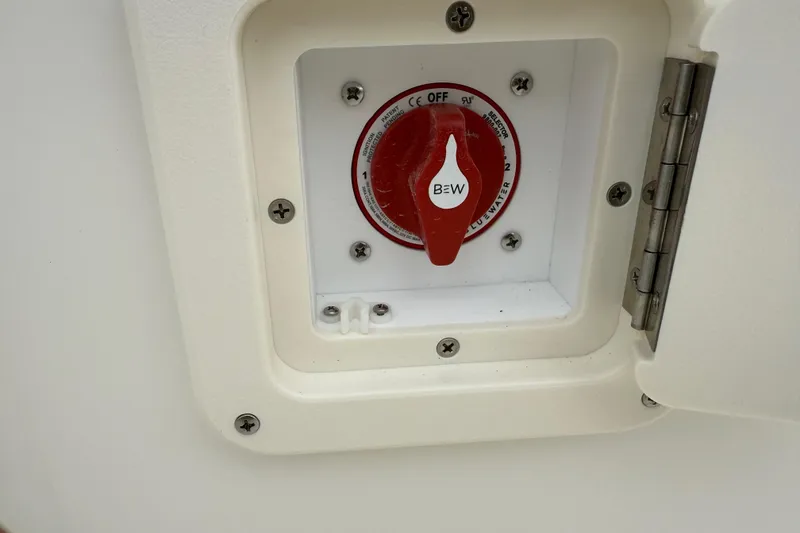 Slide: The Image of Battery switch on a 2026 Key West 203 FS boat, red knob in white compartment. - 25
