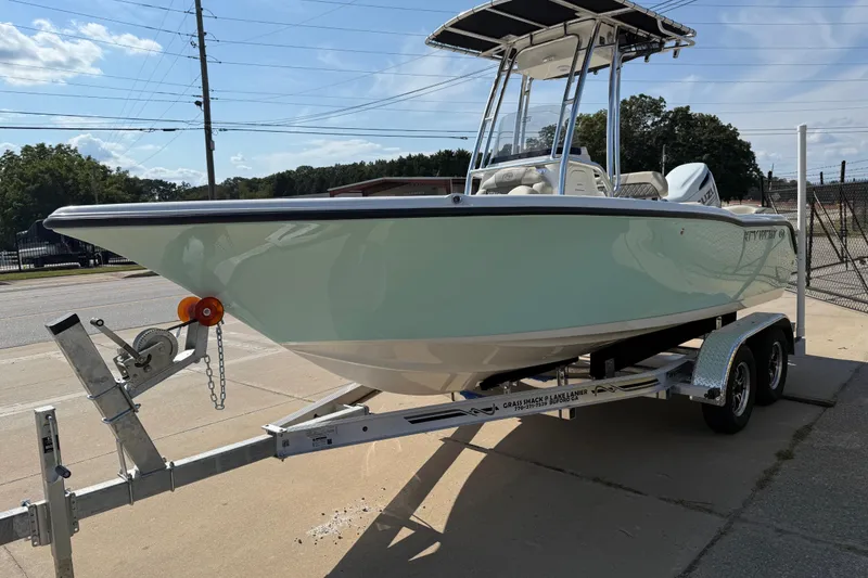Slide: The Image of 2026 Key West 203 FS boat on trailer, parked outdoors under clear sky. - 3