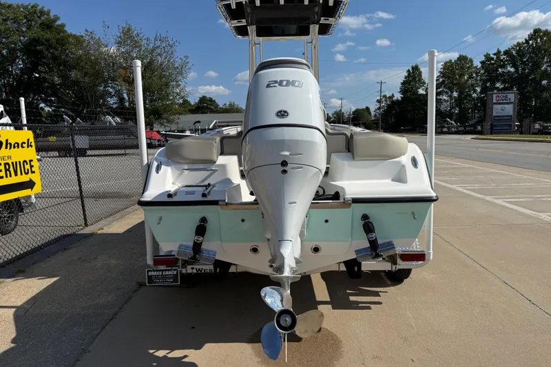 Slide: The Image of 2026 Key West 203 FS boat with powerful outboard motor, parked on a sunny day. - 4