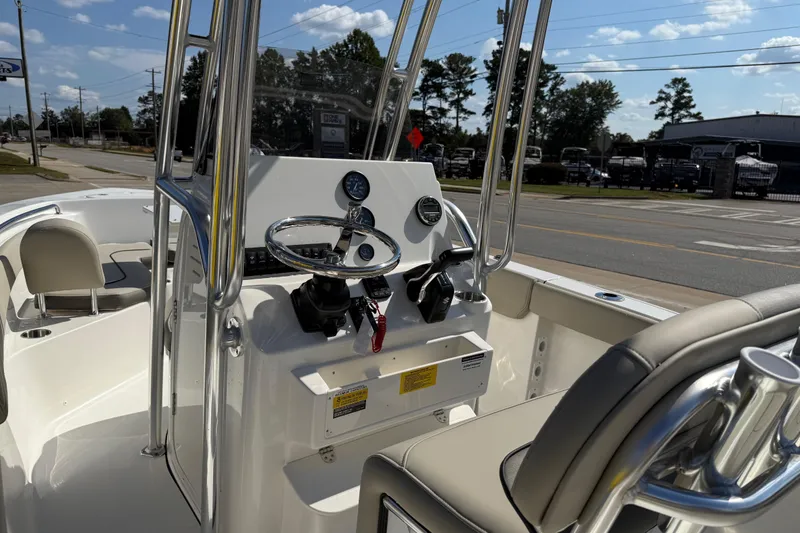 Slide: The Image of 2026 Key West 203 FS boat interior with steering console and seating. - 40