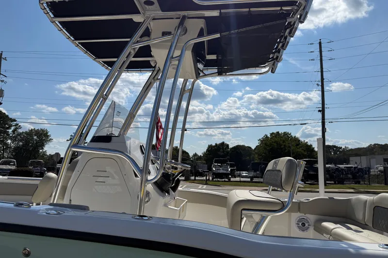 Slide: The Image of 2026 Key West 203 FS boat with T-top, parked outdoors under a sunny sky. - 41