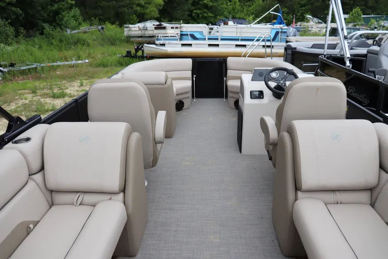 Slide: The Image of 2025 Flagship Endurace 22 CU pontoon boat with beige seating and steering console. - 9