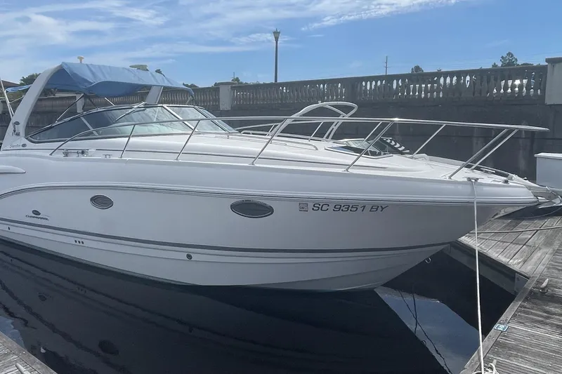 The Image of 2005 Chaparral 290 Signature boat docked, featuring sleek design and white exterior. - 0
