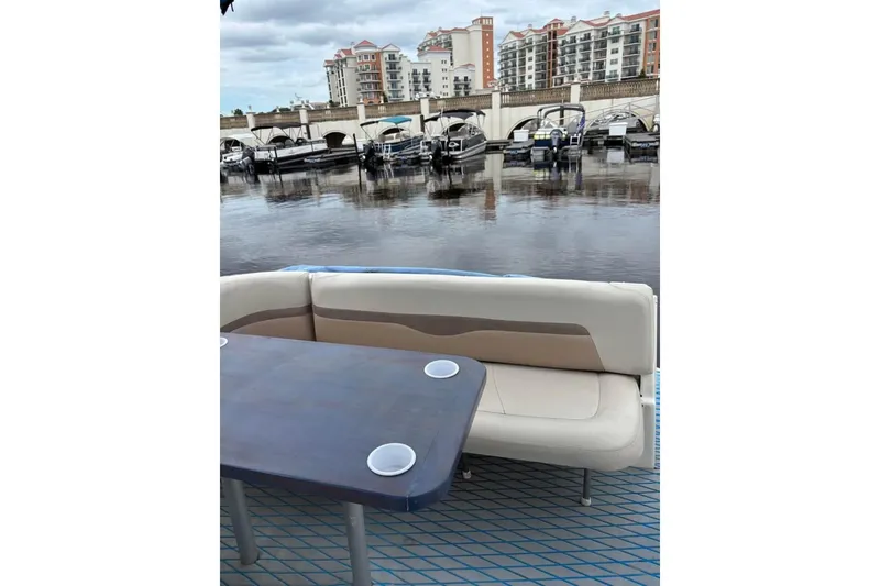 Slide: The Image of 2005 Chaparral 290 Signature boat interior with seating and table, docked at marina. - 16