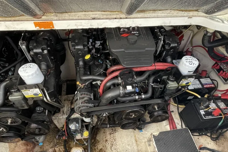 Slide: The Image of Engine compartment of a 2005 Chaparral 290 Signature boat, featuring dual engines and batteries. - 19