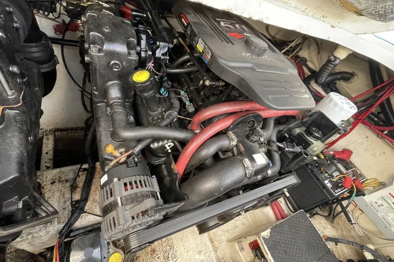 Slide: The Image of Engine compartment of a 2005 Chaparral 290 Signature boat, featuring a MerCruiser engine. - 20