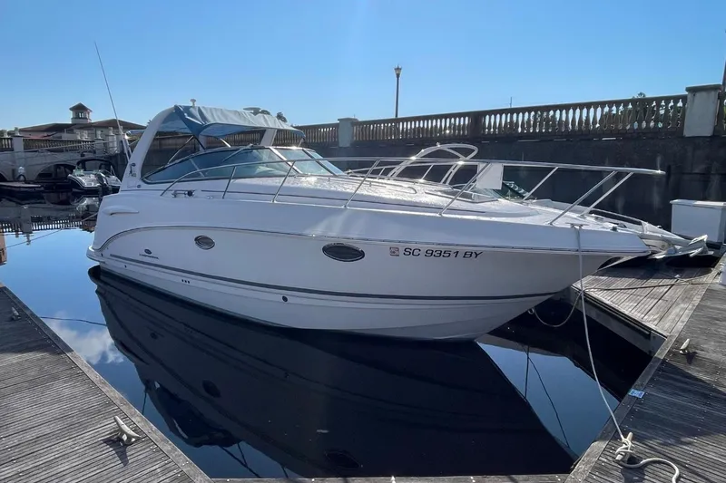 Slide: The Image of 2005 Chaparral 290 Signature boat docked in a marina under clear blue sky. - 3