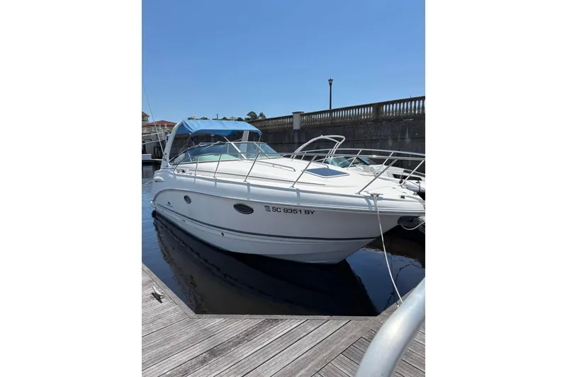 Slide: The Image of 2005 Chaparral 290 Signature boat docked at marina under clear blue sky. - 4