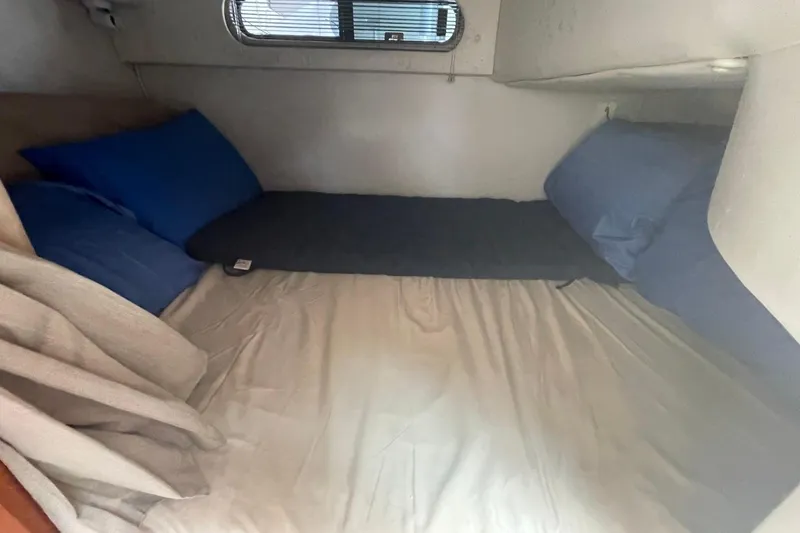 Slide: The Image of 2005 Chaparral 290 Signature cabin interior with cozy bedding and pillows. - 8