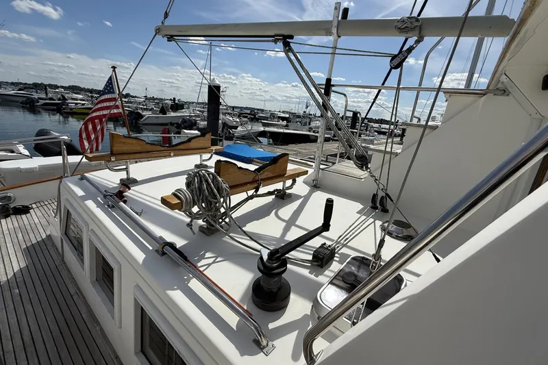 Slide: The Image of 1999 Grand Banks 42 Classic yacht deck with American flag, docked at marina. - 19